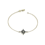 Gold bracelet in the shape of a compass rose and black diamonds